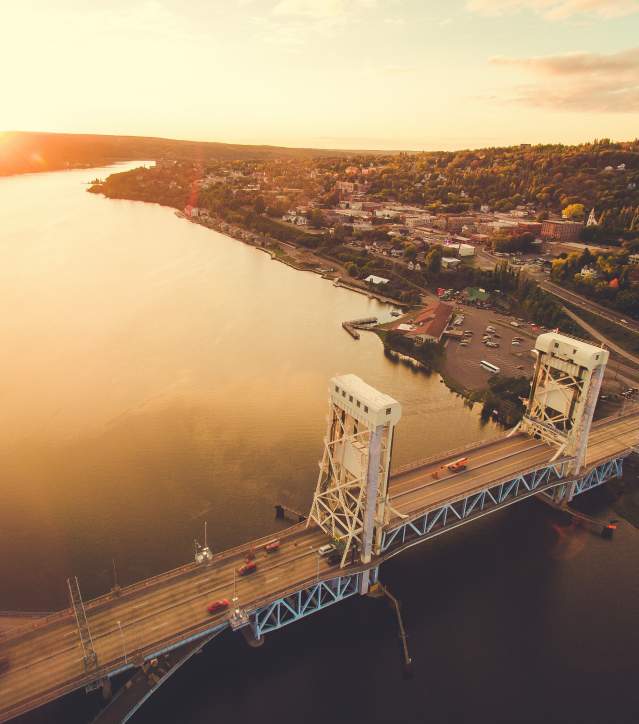 Aerial shot of Portage Lake Lift Bridge at sunset in fall