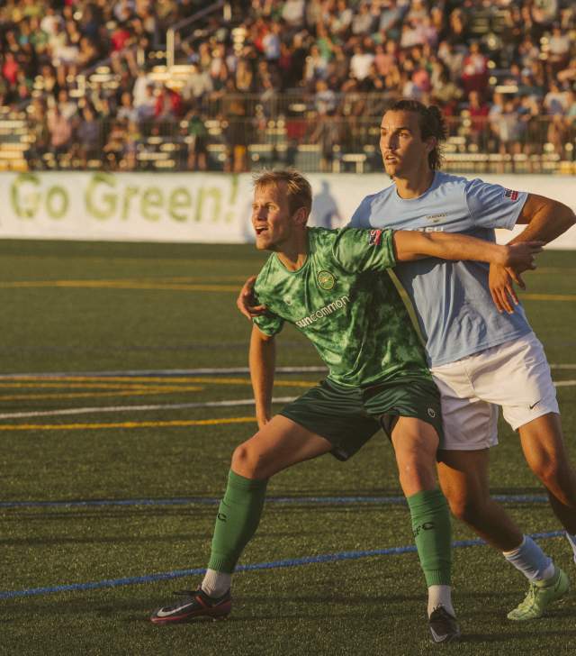 Vermont Green soccer player blocks opposing team