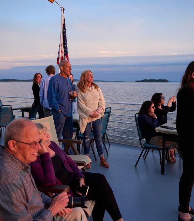 people taking photos of the sunset over Lake Champlain on the Spirit of Ethan Allen