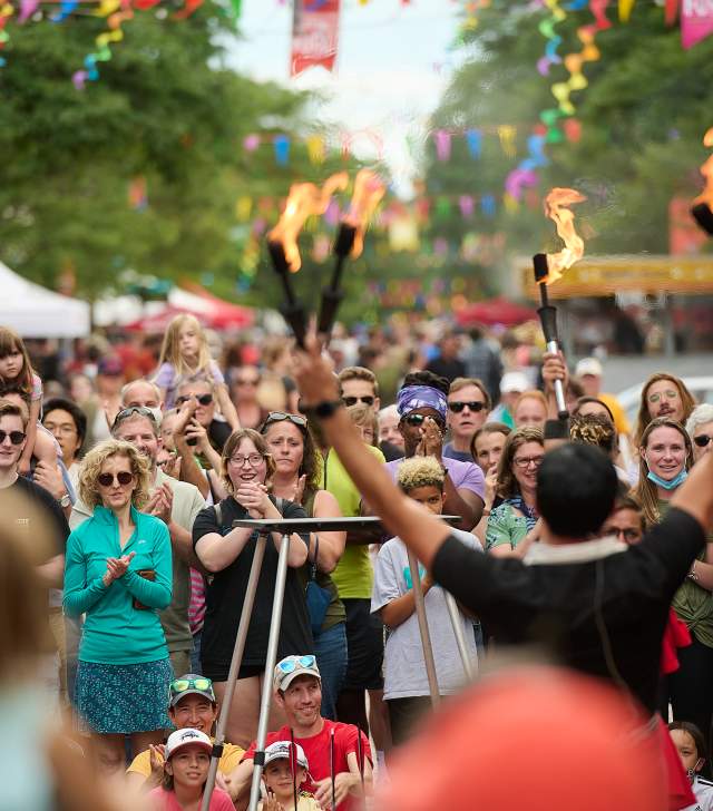 gathering of people celebrating fire dancer