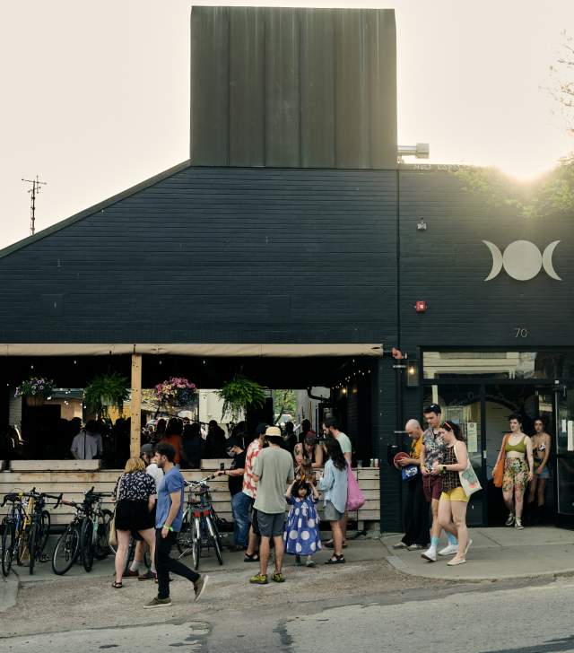 Brewery with locals gathering outside, enjoying the summer sun