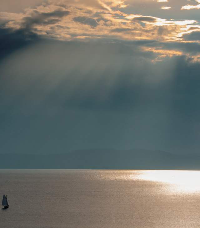 Calm Lake Champlain with solo sailboat