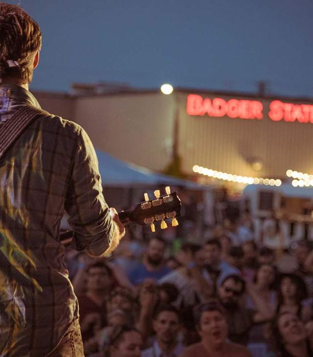 Guitar Player in front of crowd at outdoor event