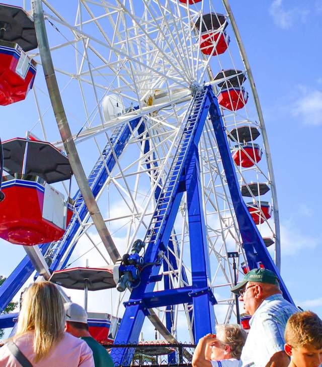 Families watch the farris wheel ride at Bay Beach Amusement Park