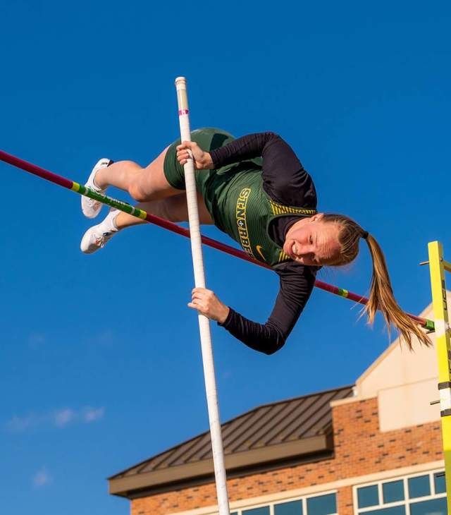 St. Norbert College pole vaulter clears the bar during compitition