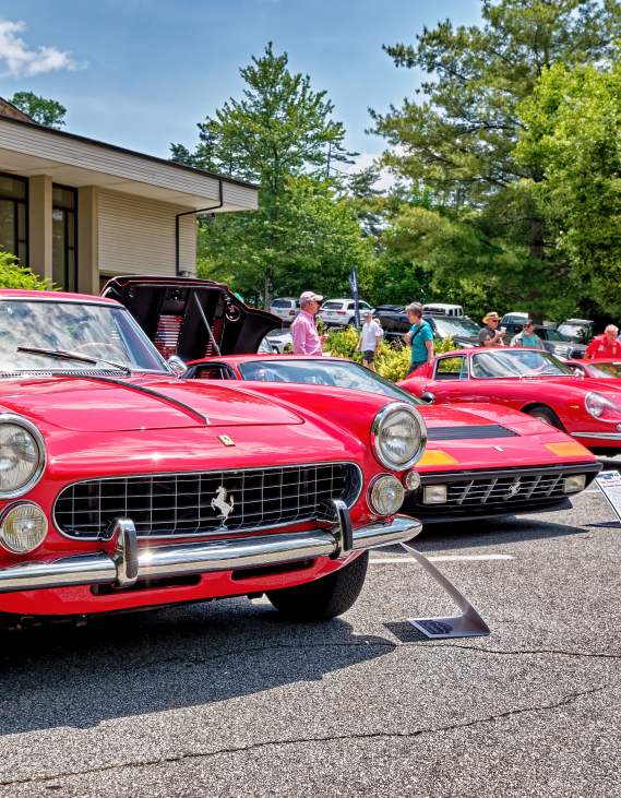 Five vintage Ferrari cars lined up on display for the Highlands Motoring Festival.