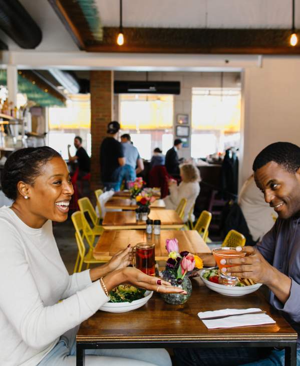 Couple sitting and dining at cafe