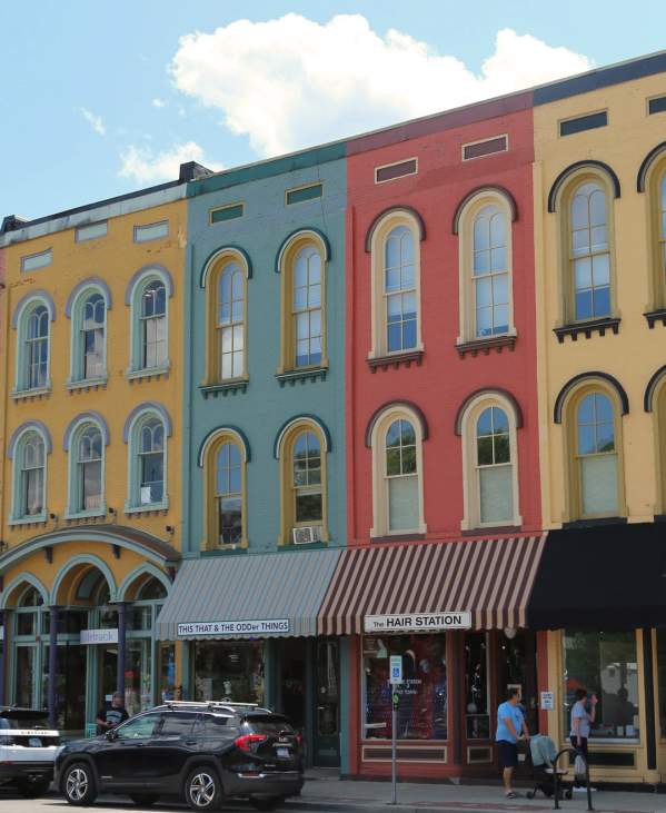 People walking by colorful buildings in Depot Town in Ypsilnati