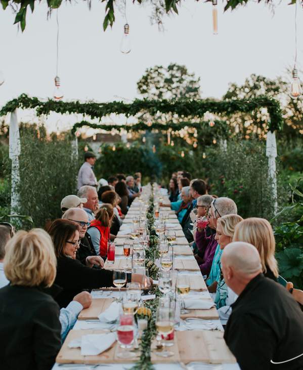 Group having an outdoor dinner in a garden at Cornman