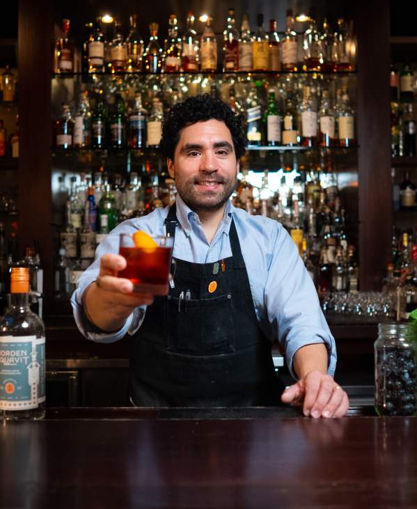 Bartender holding up a drink at The Last Word
