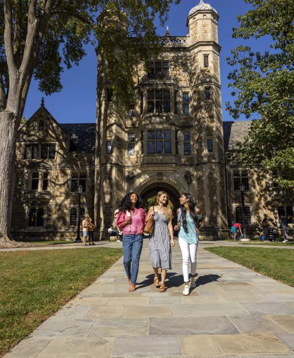 Three female students walking in U-M Law Quad