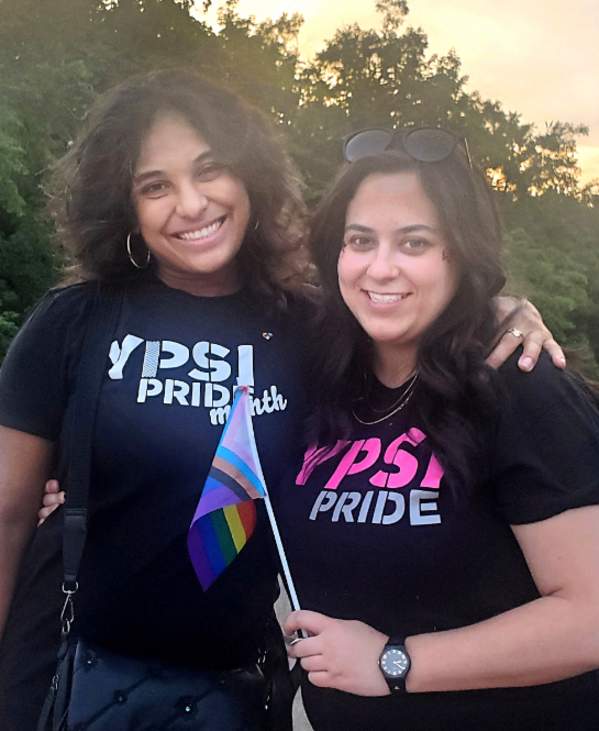 Two women on bridge wearing Ypsi Pride shirts