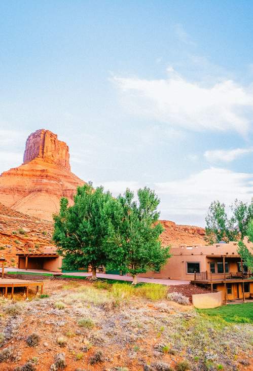 Exterior of Adobe-style homes set into Moab’s red rocks.