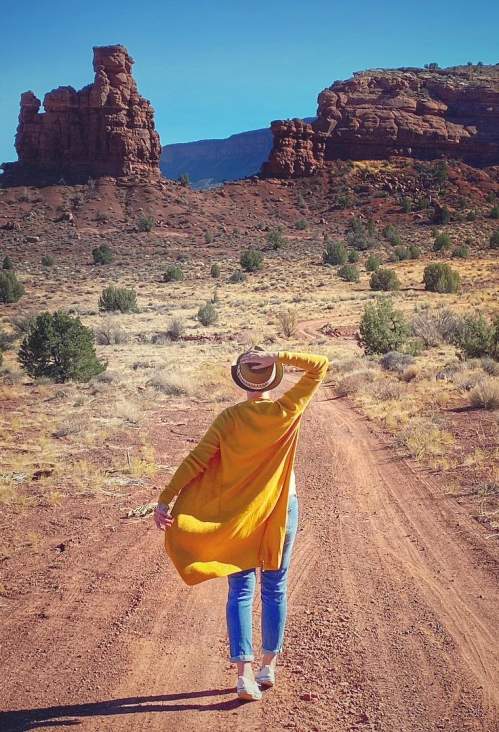 woman walking on a dirt road