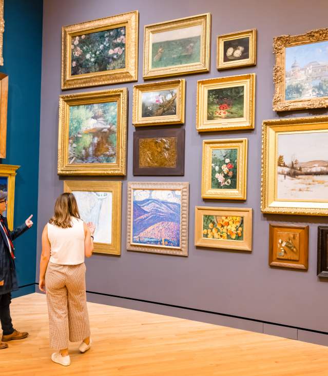 Two people look at art in a gallery at Crystal Bridges Museum of American Art