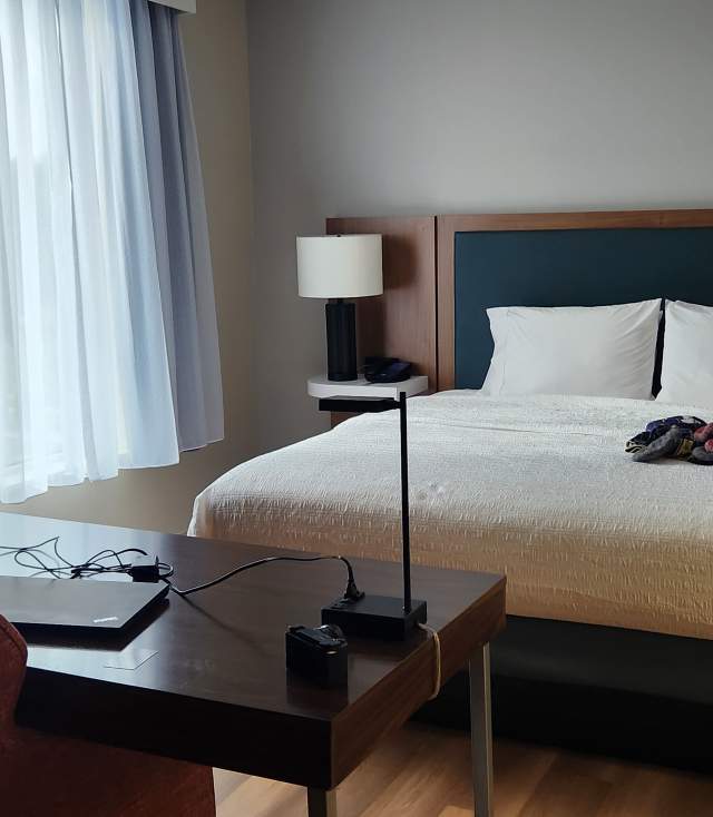 King size hotel room with bed and desk