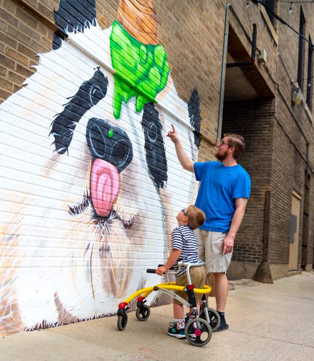 Father and son enjoying the panda mural in Fort Wayne, Indiana.