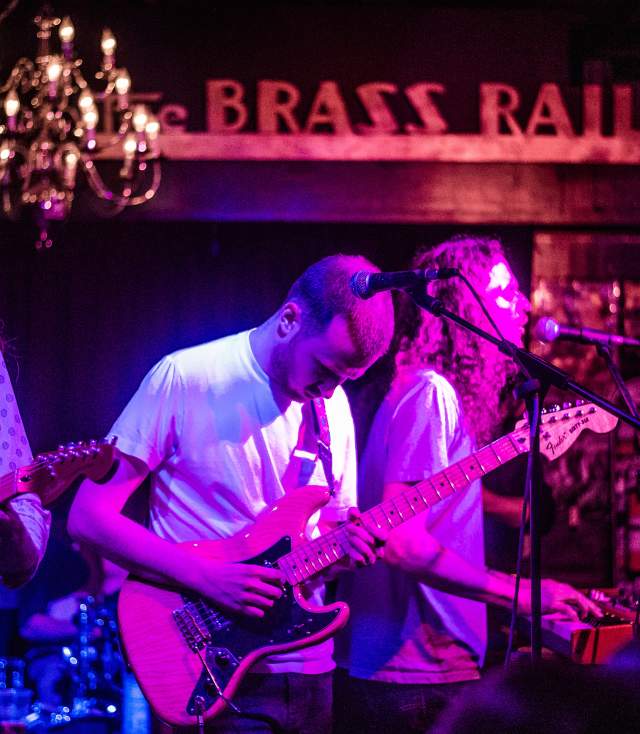 Band playing in dark lighting at the Brass Rail
