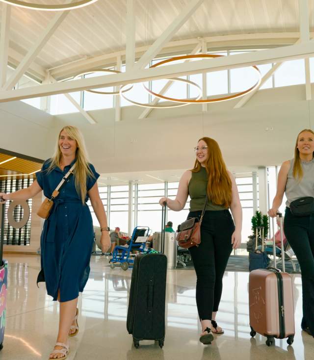 Women walking through the Fort Wayne International Airport Terminal with suitcases