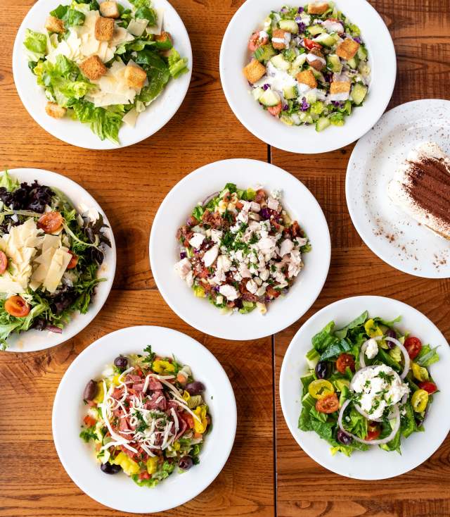 A full table of Italian food, including Pizza, salad, appetizers, and dessert. At Giordano's in Fort Wayne