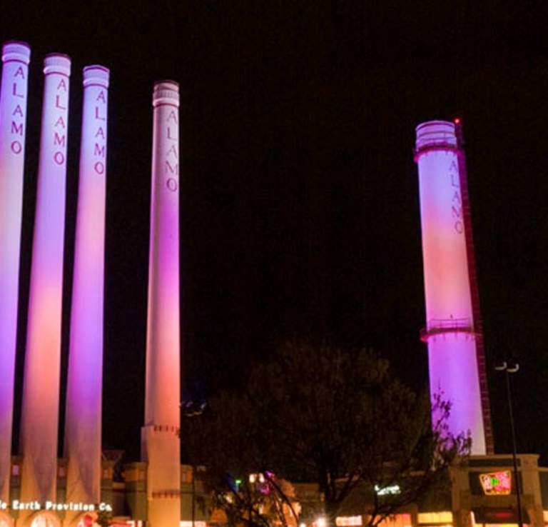 Smokestacks at mall lit with pink lighting