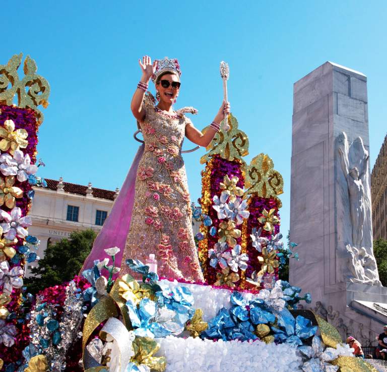 Parade in downtown San Antonio with woman on float waving