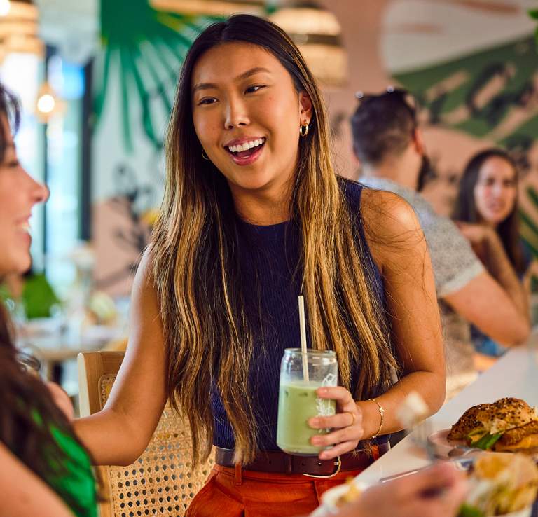 Two girls laughing over lunch