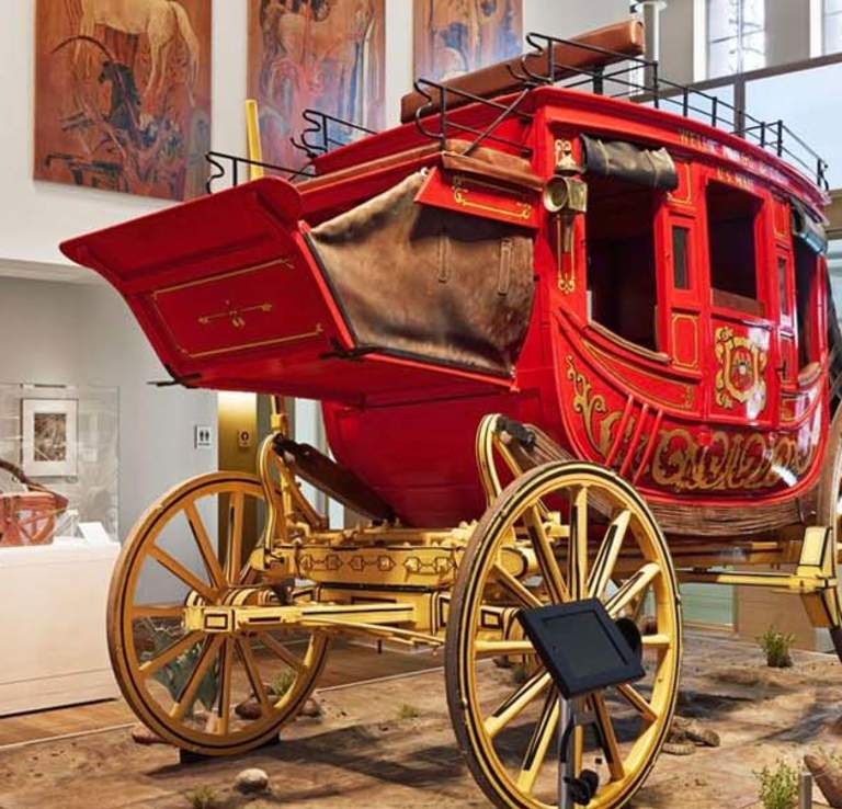 Red covered wagon inside musem exhibit