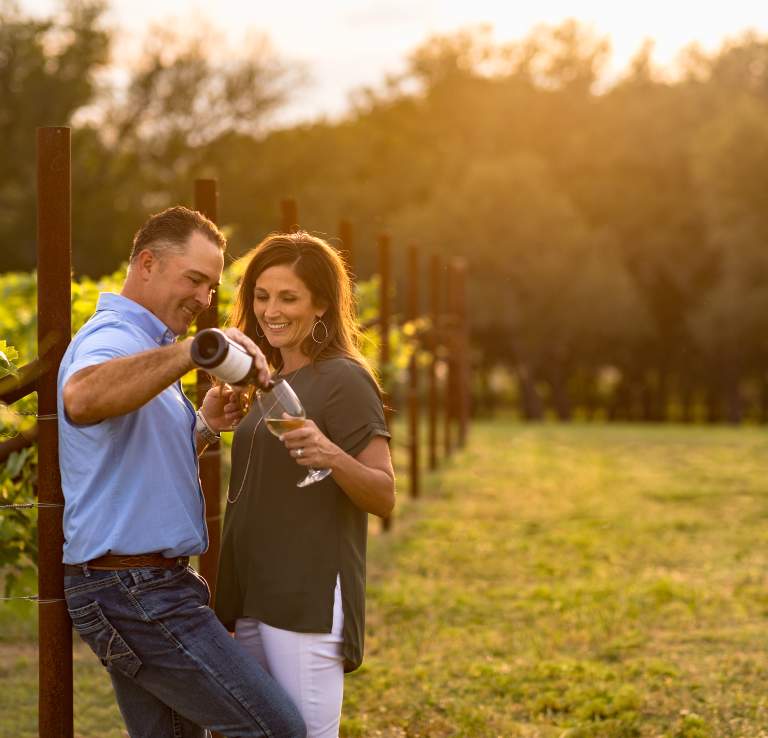 Man and woman enjoying wine at Signor Vineyards in Fredericksburg
