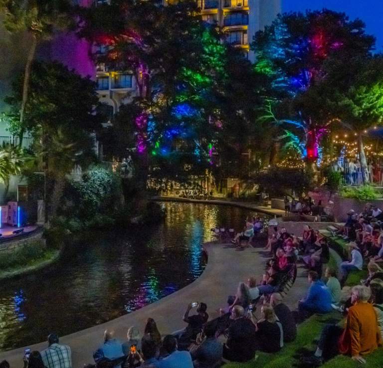 People on lawn enjoying concert