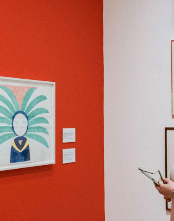 woman in headphones looking at art