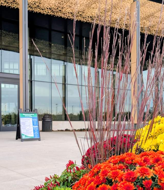 Central Park Woodbury main entrance decorated with flowers and exterior lights.
