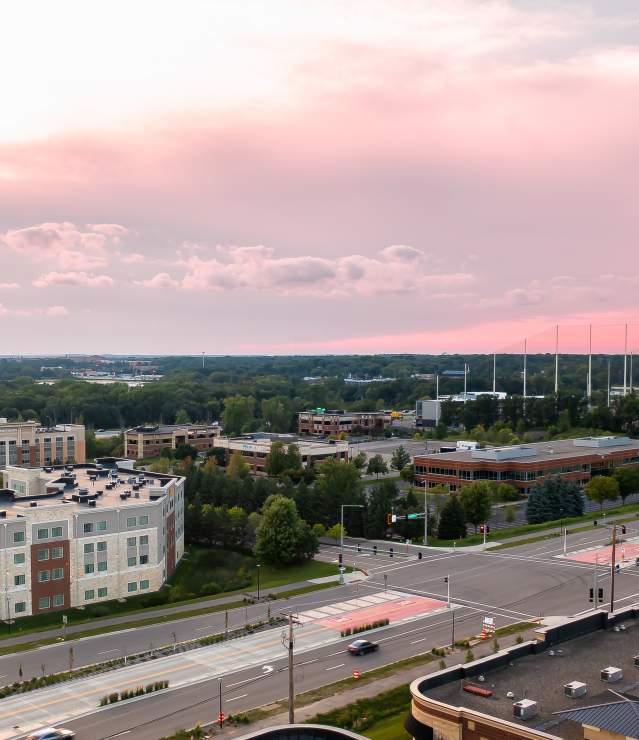 Aerial photo of Topgolf, hotels and other businesses at sunset.