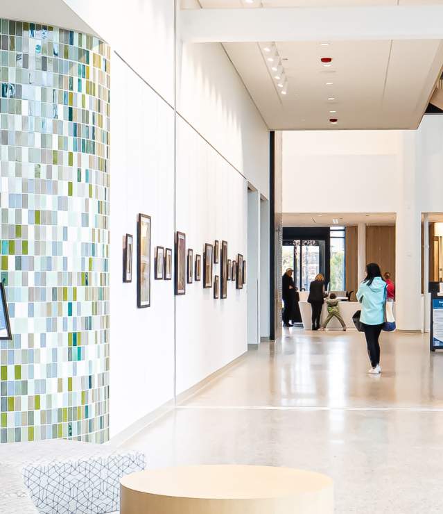 Woodbury Central Park photo with a guest gazing at lobby photos.