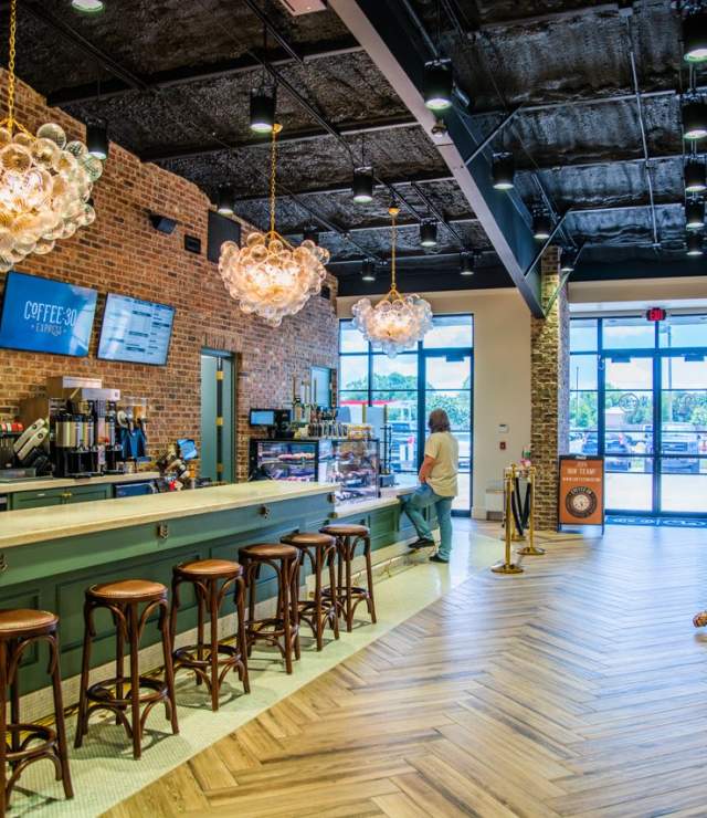 elegant light fixtures, wooden floors, green, gold, and granite bar area inside coffee:30