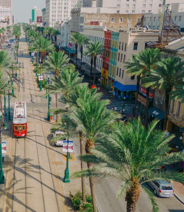 Streetcars Roll Along Canal Street - Downtown New Orleans
