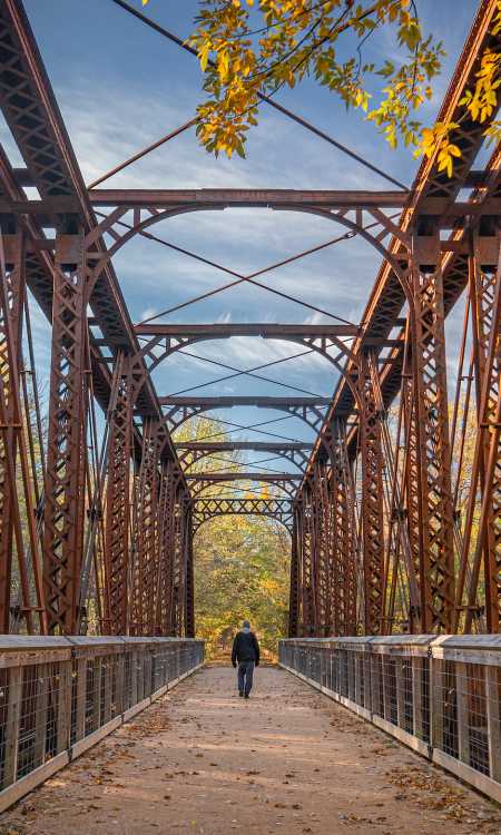 Person walks on Iola Bridge in the Fall