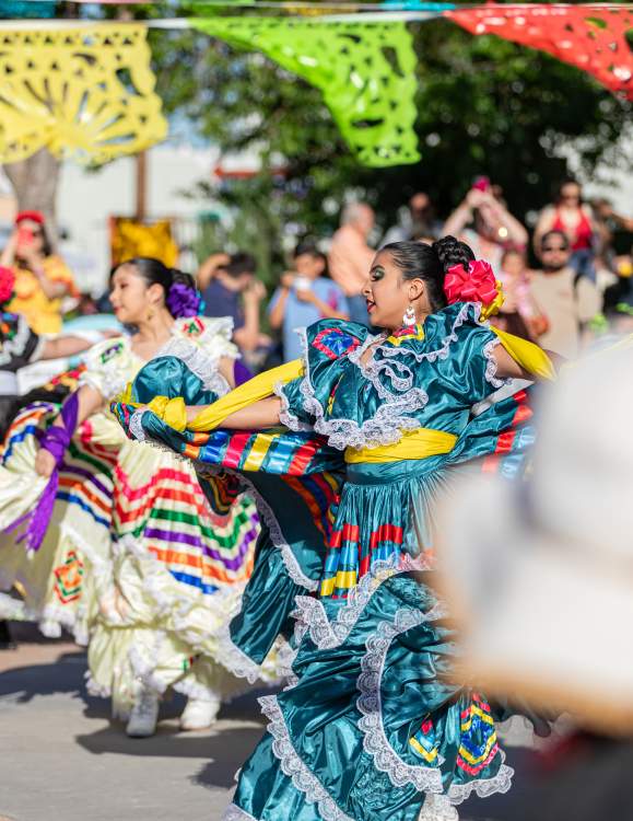 Photo of women in traditional Jalisco Ribbon Dresses dancing at Pat Coursey Park during Cinco De Mayo Celebration in 2025.