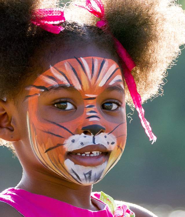 Young girl with face painted at downtown event