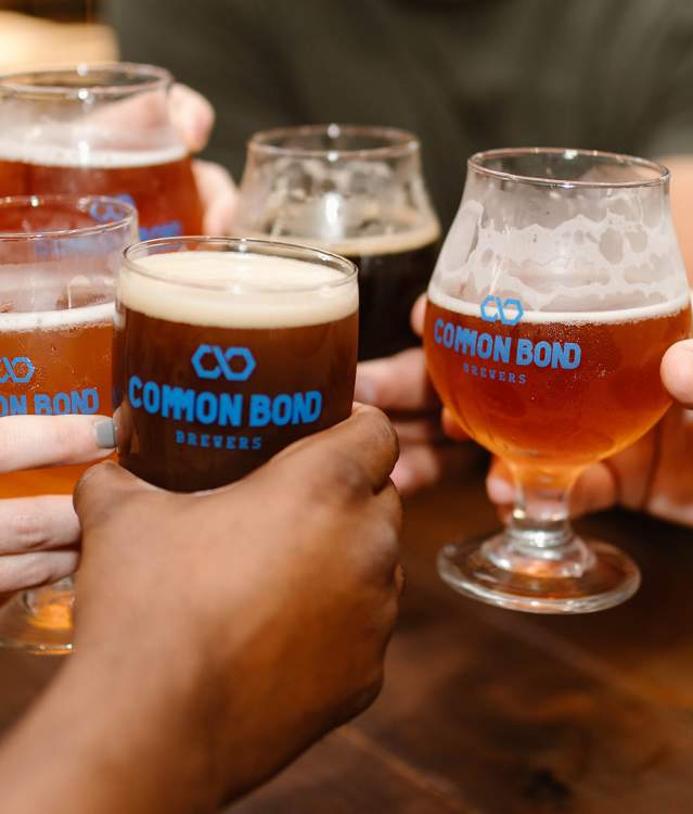 People Cheering with beer at Common Bond Brewers