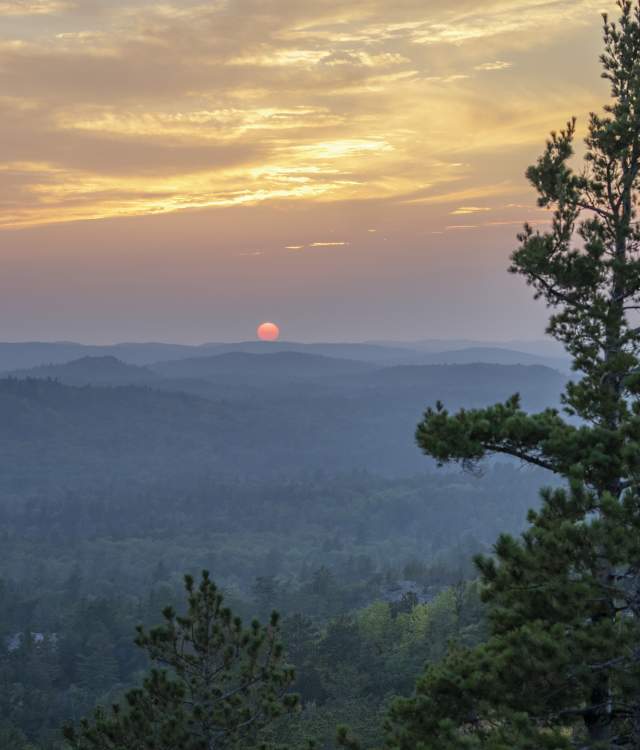 View of a warm summer sunset from Sugarloaf Mountain in Marquette, MI