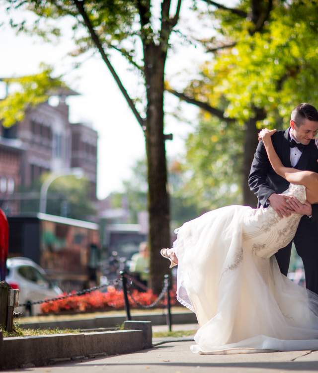 groom dipping his bride on broadway
