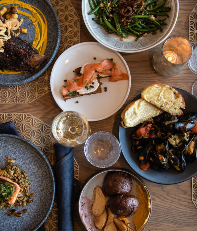 A table full of dishes from Aria -- The Restaurant at Saint Kate