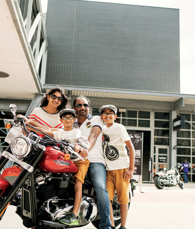 family of four on and around a Harley Davidson Motorcyle