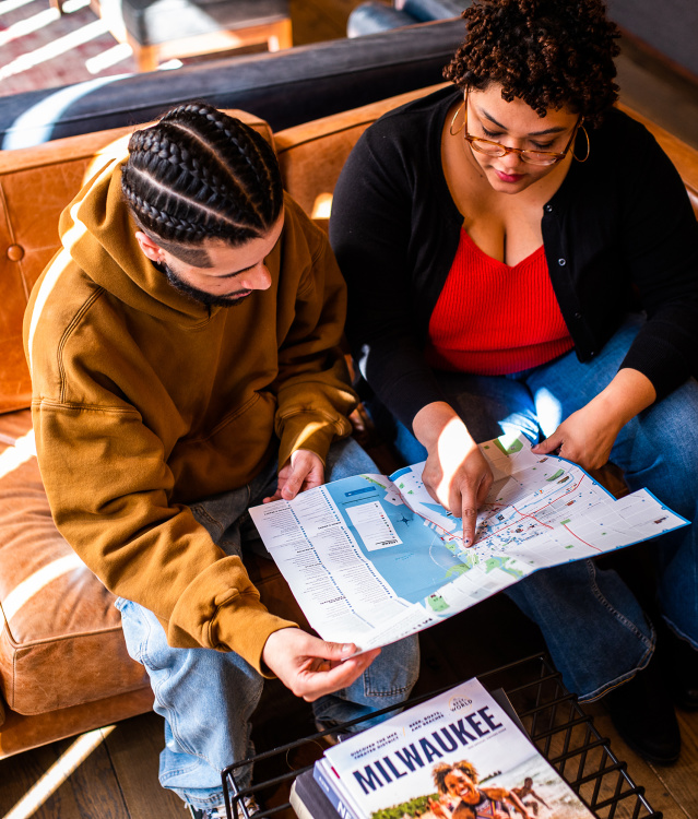 two people sitting on couch looking at the OVG map