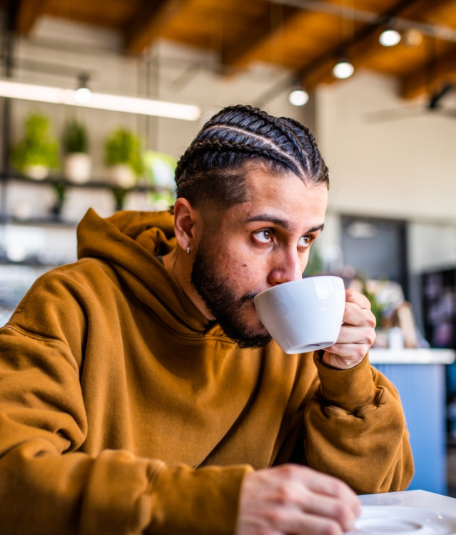Man drinking coffee at Valentine Coffee Roasters