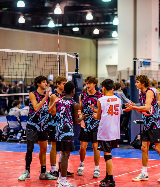 volleyball team of teenage boys congratulating each other in a huddle