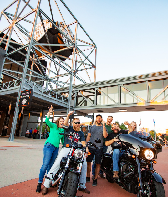 Friends on/around motorcycles at Harley Davidson