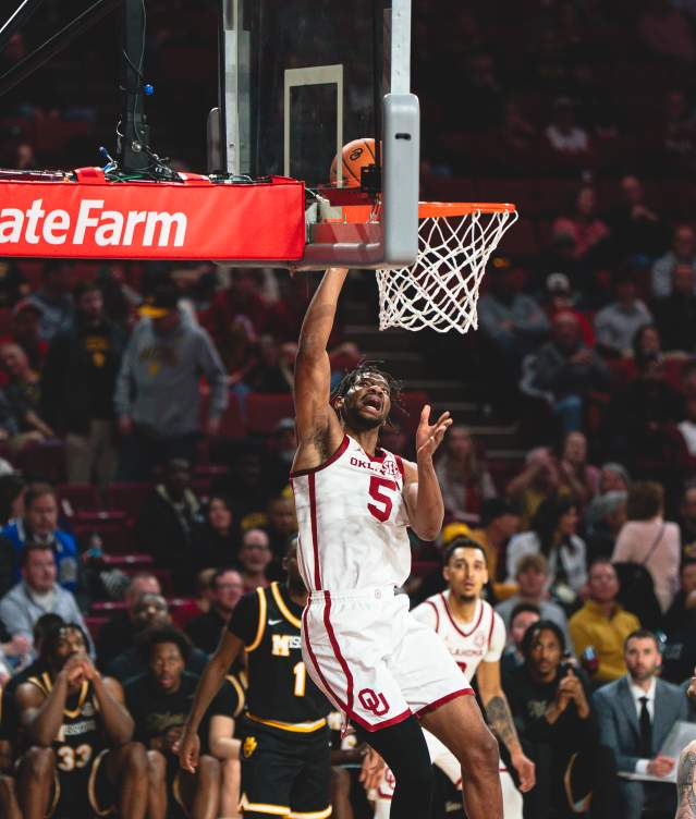 OU Men's Basketball player shooting a ball