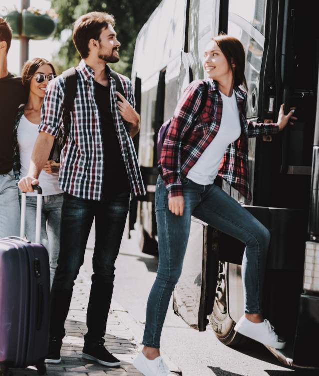 A group of individuals boarding a charter bus in Norman, Oklahoma